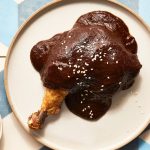 A dark, textured pile of dried Chilhuacle Negro chiles, a key rare ingredient for Oaxacan mole negro.