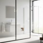 Frosted glass partition separating modern bedroom bathroom with white fixtures and natural light