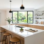 Bright modern kitchen featuring clean marble countertops.