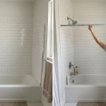 Tape measure showing wall-to-wall shower alcove width at rod height