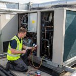 commercial VRF heat pump system being serviced on a rooftop installation