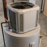 heat pump water heater installed in a basement with visible refrigerant coil