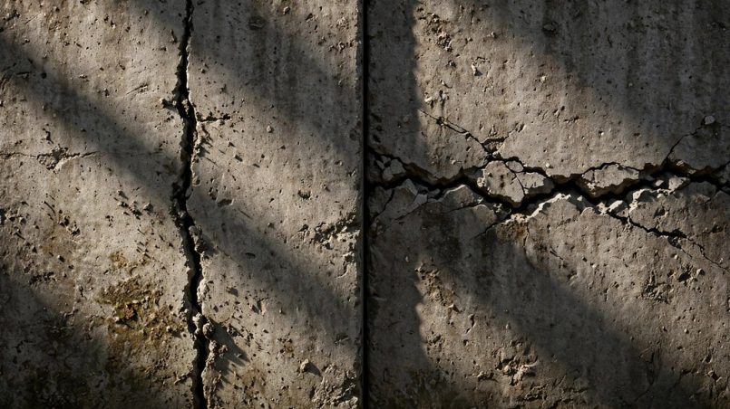 Foundation wall split showing a vertical crack on one side and a horizontal crack on the other